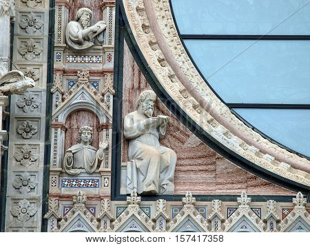 Architectural details of Duomo facade - SienaTuscanyItaly. The Duomo of Siena which was built in the 12th and 13th centuries is one of the prettiest churches in Gothic style in Italy