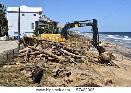 VILANO BEACH, FLORIDA, USA - OCTOBER 19, 2016:  Heavy construction equipment clearing beach debris caused by hurricane Matthew hitting along the east coast of Florida on October 7, 2016.