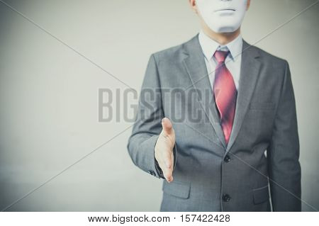 Business Man Giving Dishonest Handshake Hiding In The Mask - Business Fraud And Hypocrite Agreement