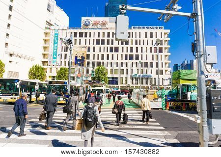 TOKYO - OCTOBER 24: Pedestrians at Shibuya crossing October 24 2016 in Tokyo JP. The famed crossing is one of the most well known examples of a scramble crosswalk.