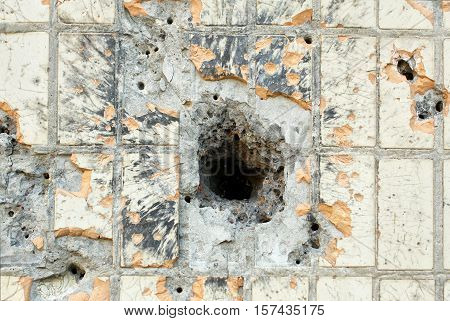 hole from a shell in the wall of the house