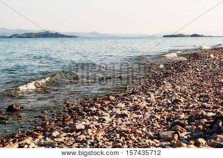 Waves hitting big rocks on Lake Baikal