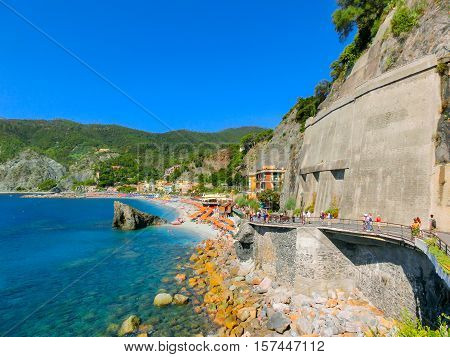 Monterosso, Italy - People on the coastline of Monterosso in Italy. Monterosso is one of five famous coastline villages in the Cinque Terre National Park.