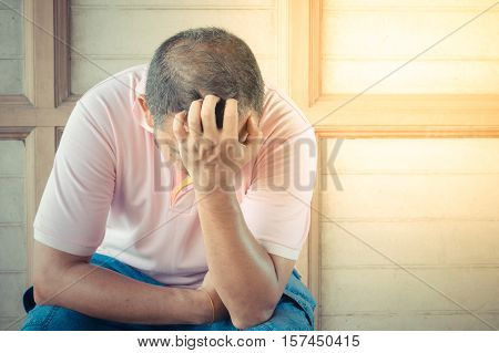 Anxious asian man feeling sadness and stress sitting on the chair process in vintage style