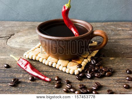 black coffee with pepper spicy. wooden background. White background