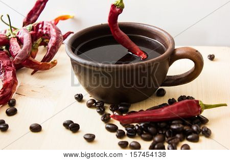 black coffee with pepper spicy. wooden background. White background