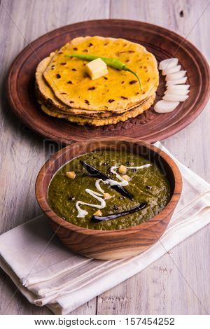 corn flour flat bread or roti or Makki Ki Roti with sarso da Saag or mustard leaves curry, Indian Food popular in winter season in north india