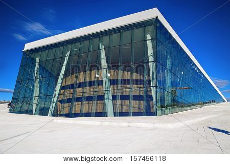 OSLO NORWAY - AUGUST 17 2016: Tourist on the Oslo Opera House which is home of Norwegian National Opera and Ballet and National Opera Theatre in Oslo Norway on August 172016.