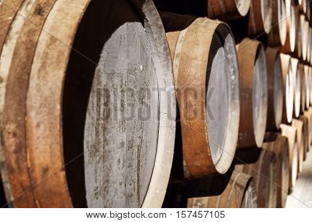 Closeup View Of Oak Barrels Stacked In The Old Cellar With Aging Port Wine