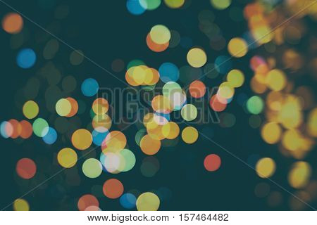 background with natural bokeh defocused sparkling lights. Colorful metallic texture with twinkling lights. Bright and vivid colors
