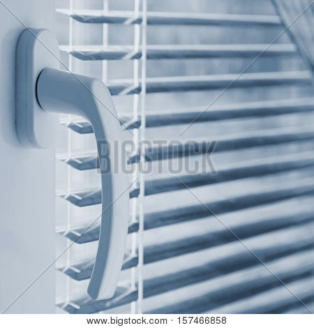 New modern plastic window and interior rooms. Blinds in a home catching the sunlight.