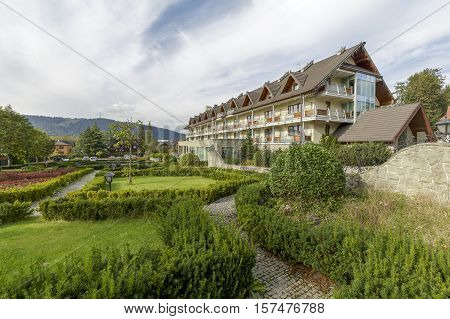 ZAKOPANE POLAND - SEPTEMBER 23 2016: Hotel Wersal that is located in a modern building with architecture reminiscent of the style of the region is surrounded by a beautiful garden providing peace