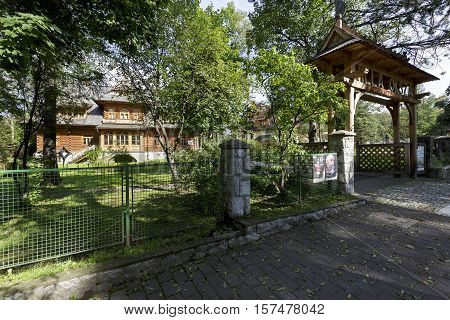 ZAKOPANE POLAND - SEPTEMBER 23 2016: Villa called Oksza is seen from the outside of the fence. Made of wood gate invites to visit museum that is located in a villa