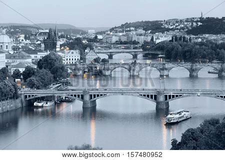 Panorama of the old part of Prague from the Letna park at dusk. View on the bridges over the river Vltava at sunset. Czech Republic. Black and white photo with the selected colorful lanterns.