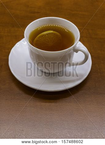 Porcelan cup of tea on the brown table