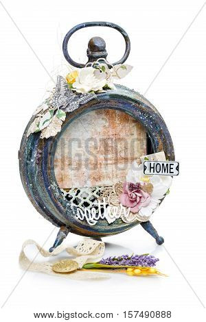 Beautiful handmade photo frame with paper details made from vintage alarm clock. Scrapbooking. Isolated on white. Copy space.