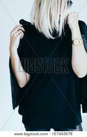 Fashion model in black clothing. Leather jacket and pants, blank t-shirt and sunglasses. Street urban style.