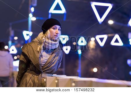 Art portrait of a beautiful girl. Gorgeous blonde girl portrait in night city lights. Vogue fashion style portrait of young pretty beautiful woman with long blonde curly hair.