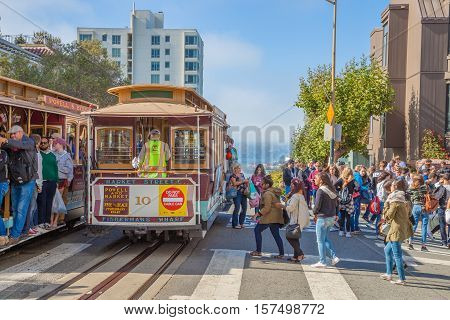 San Francisco, CA, United States - August 16, 2016: two Cable Car, Powell-Hyde lines meet. Crowds of tourists to the famous landmark of Lombard Street, one of the most crooked streets in the city.