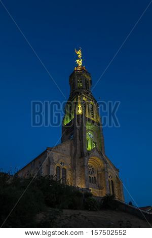 Church of Saint Michael in Saint-Michel-Mont-Mercure France with a large figure of the Archangel Michael at the top of the tower