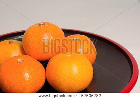 Mandarin oranges in Japan on red lacquer lacquerware