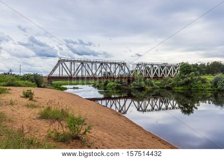 Railway bridge over the river Volchina. The beach next to the railway bridge, Maksatikha station.