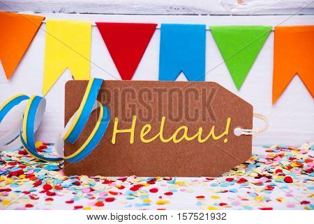 Brown Label With German Text Helau Means Happy Carnival. Party Decoration Like Streamer And Confetti. White Wooden Background. Greeting Card For Celebrations