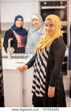 Group of Muslim women in kitchen making food