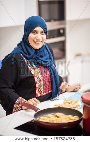 Group of Muslim women in kitchen making food