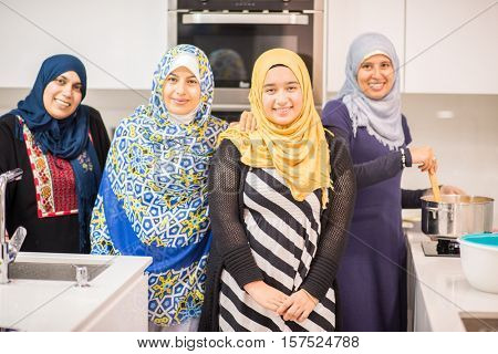 Group of Muslim women in kitchen making food