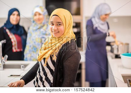 Group of Muslim women in kitchen making food