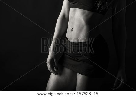 Gorgeous women exercise sexy body on the black and white photo.