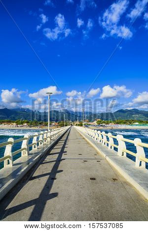 Pier footpath promenade beach and Apuane mountains in Forte dei Marmi Versilia Tuscany Italy