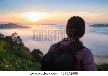 Rear view of young woman traveling on mountain.