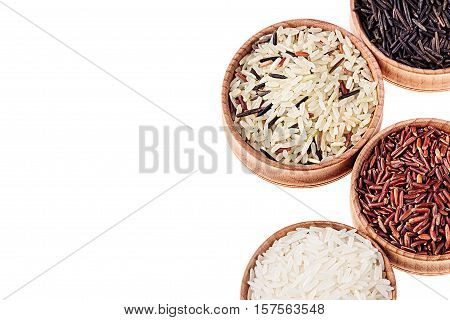 Red black and white rice close-up in wood bowls on white background. Isolated. Rice texture background.