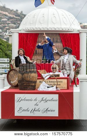FUNCHAL MADEIRA PORTUGAL - SEPTEMBER 4 2016: Men in historical fashion dress raise toasts durnig historical and ethnographic parade of Madeira Wine Festival in Funchal. Madeira Portugal