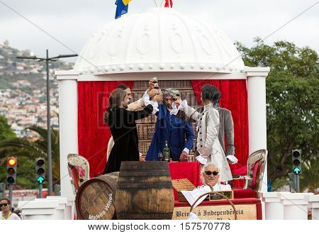 FUNCHAL MADEIRA PORTUGAL - SEPTEMBER 4 2016: Men in historical fashion dress raise toasts durnig historical and ethnographic parade of Madeira Wine Festival in Funchal. Madeira Portugal