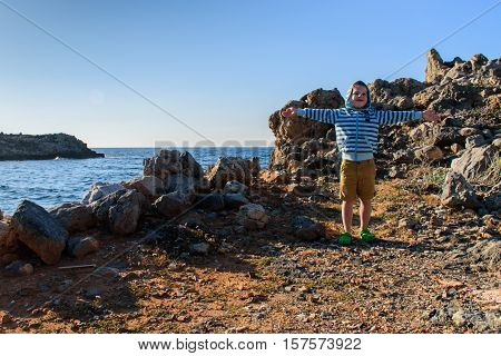 A boy of five years old walking on rocky terrain