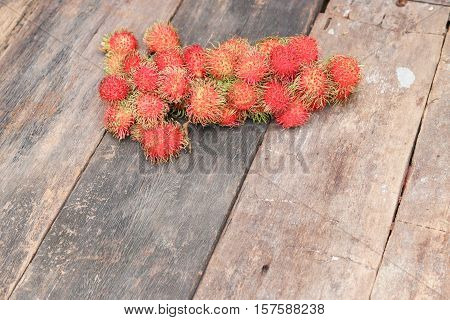rambutan sweet fruit fresh on wood background :Select focus with shallow depth of field.