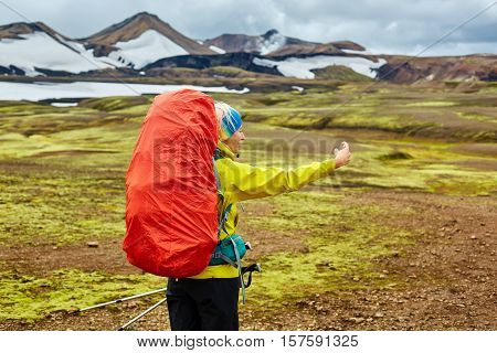 woman hiker photographer taking selfie on the rhyolite mountains background in Iceland
