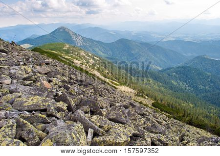 Carpathian mountains in autumn. Stone field on the way to Mount Homiak. Cloudy sunny day