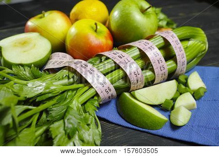 Green vegetables and fruits - celery shoots and apples healthy fitness diet concept