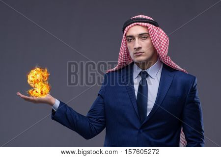 Arab businessman with burning dollar sign