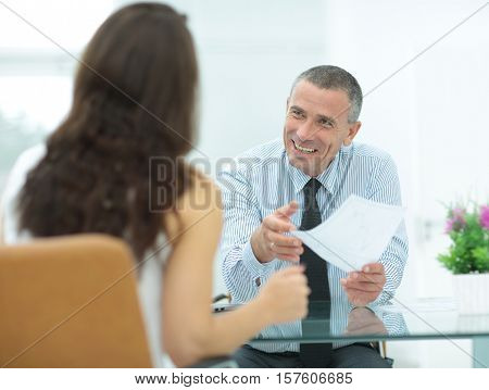 boss discusses with the assistant business documents in the offi