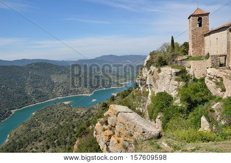 The Antique Church Is Extant In The Old Small Village On The Abrupt Cliff In The Prades Mountains.