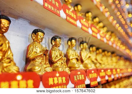 Side View On Different Small Golden Buddha Statues In The Interior Of The Ten Thousand Buddhas Monas