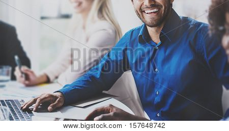 Portrait of successful hispanic businessman smiling on the business meeting with partners in modern office.Horizontal, blurred background