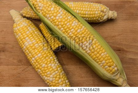 Corn on the cob on a wooden background
