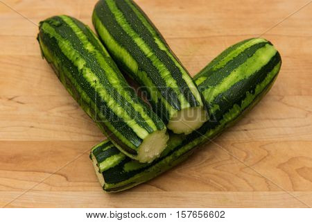 Peeled zucchini on a wooden cutting board