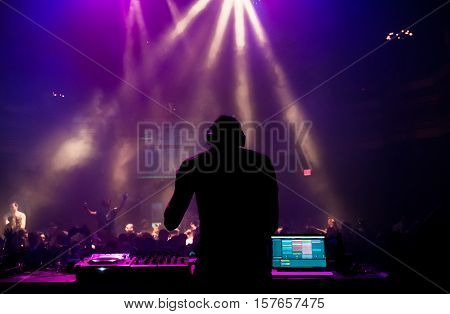 Silhouette of a DJ performing at a concert